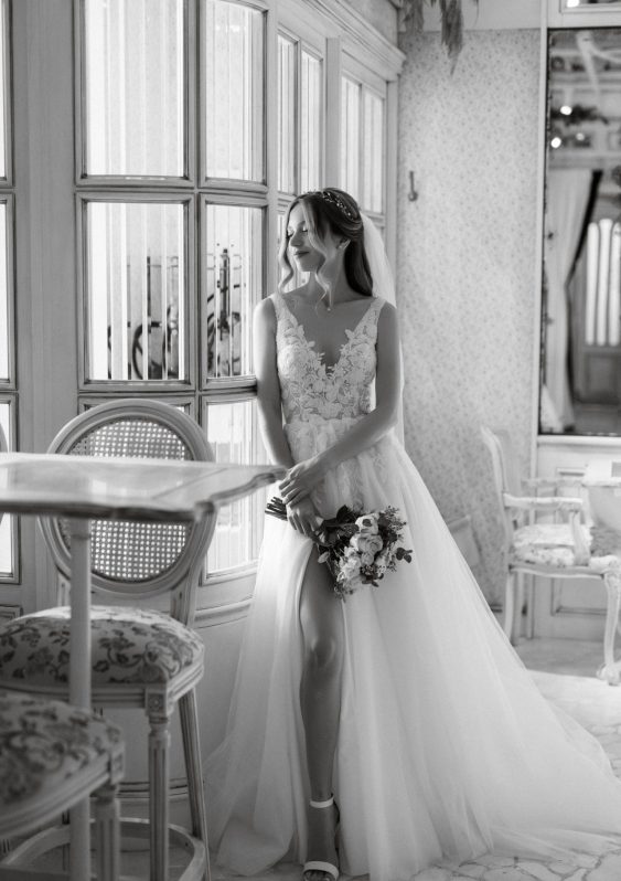 portrait of a bride in a white dress in a bright cafe with mirrors